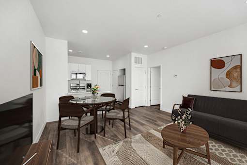 A modern living room with a dining table and chairs.