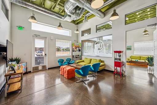 A modern office space with a variety of seating options and a view of the outdoors.