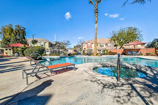 A pool with a ladder and a palm tree.