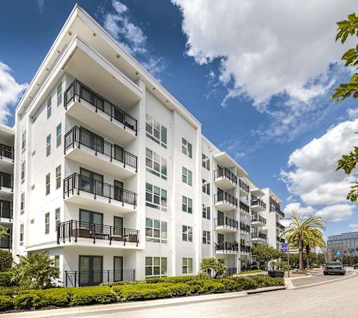A white apartment building with balconies and windows.