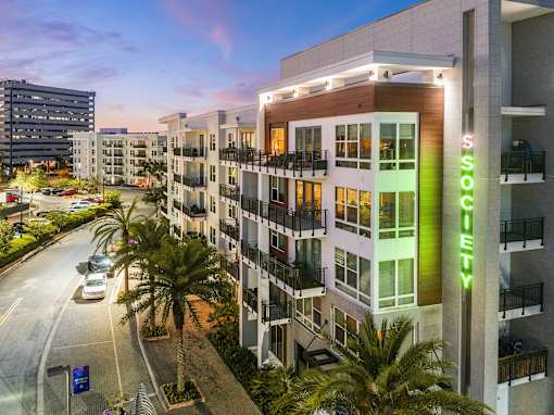 A modern apartment building with the name "Sunshine" on the side.