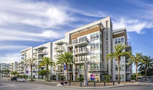 A modern apartment building with a sign that reads "CLOUD".