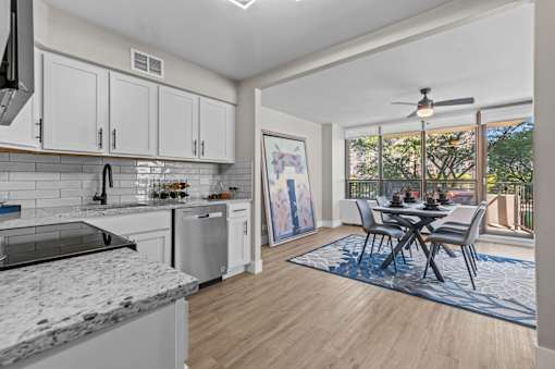 A modern kitchen with a dining table set up.