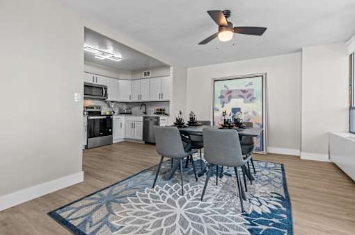 A dining room with a table set for four.