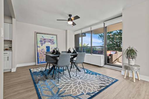 A dining room with a table set for four.
