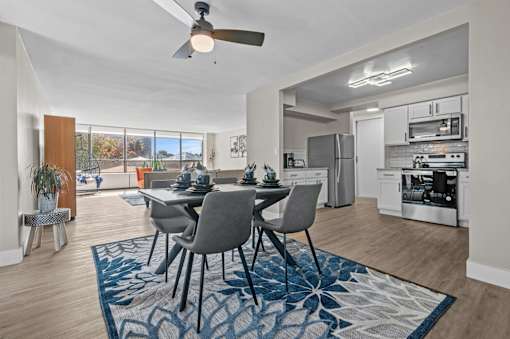 A modern dining room with a table set for four.