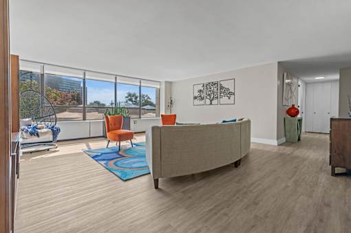 A living room with a couch, chair, and a table.