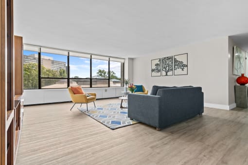 a living room with white walls and hardwood floors