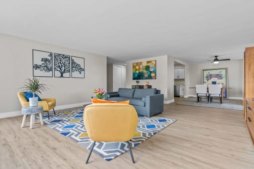 our apartments offer a living room with a gray couch and yellow chairs