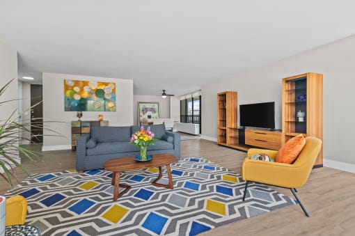 a living room filled with furniture and a large window