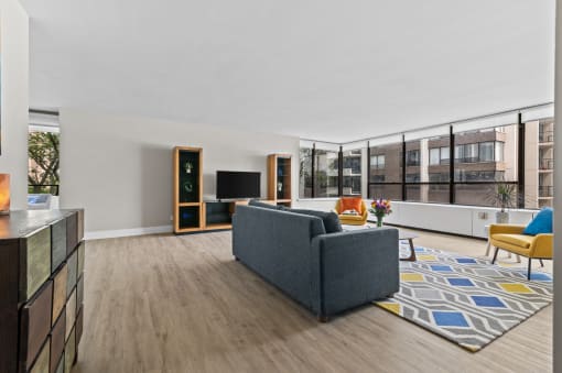 a living room with white walls and hardwood floors