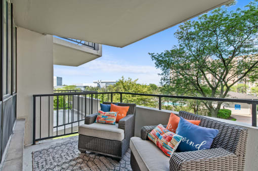 a balcony with two couches and a coffee table