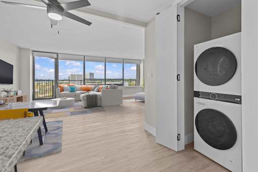 A modern living room with a washing machine built into the wall.