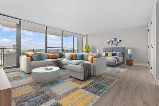 A modern living room with a large grey sofa and a coffee table.