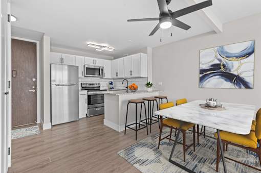 A modern kitchen with a dining table and chairs.
