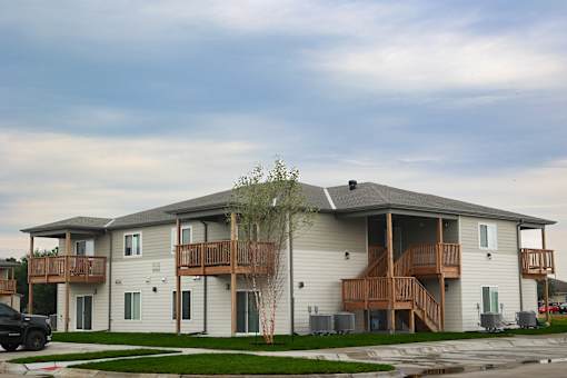 A large two story house with a balcony on the second floor.