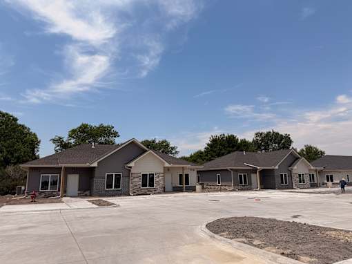 A row of new houses are being built in a suburban area.