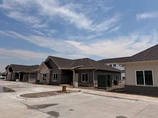 A row of houses with a clear blue sky above them.