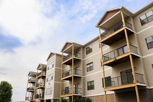 Apartment building with balconies and railings.