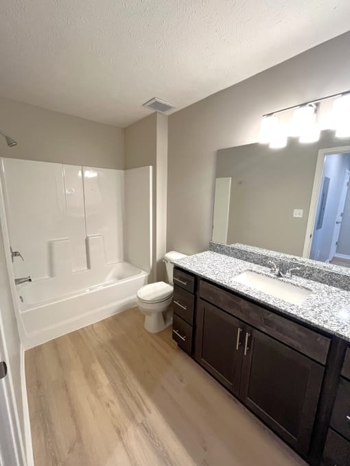 Phase 2 bathrooms with solid surface countertops in bathrooms and kitchen
