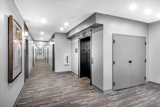 a corridor of elevators and doors in a building