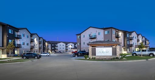 The entrance to a residential complex called The Grove is shown at dusk.