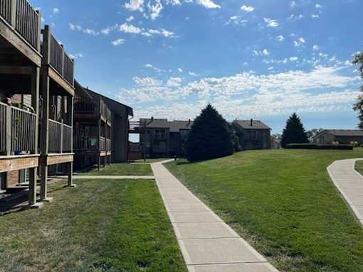 Fox Run Apartments community featuring residential buildings, green lawns, and landscaped outdoor spaces.