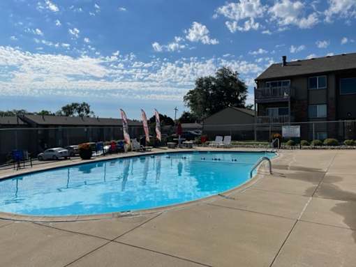 Outdoor swimming pool at Fox Run Apartments with surrounding deck space and community seating areas.