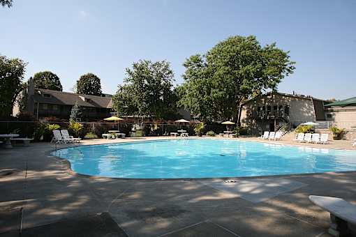 A swimming pool at Eden West, surrounded by a calm and inviting atmosphere.