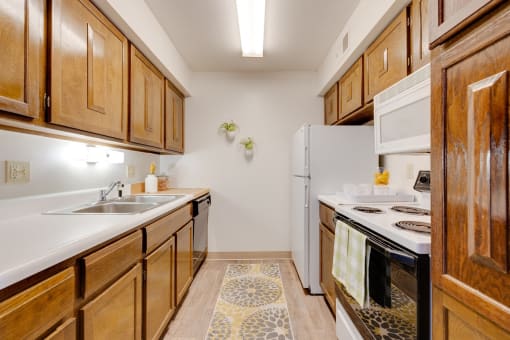 Kitchen in the two-bedroom model unit at Olde English Village, featuring spacious countertops and practical appliances.