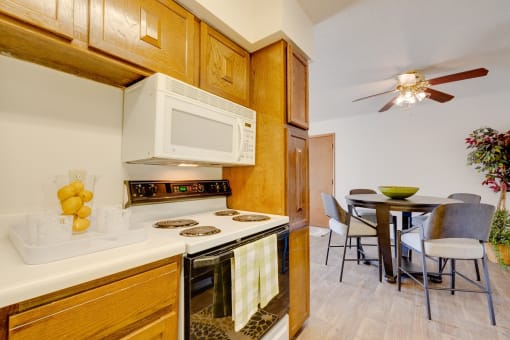 Well-equipped kitchen in the two-bedroom model unit at Olde English Village, offering plenty of storage and countertop space.