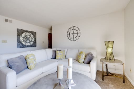 Living room of a two-bedroom model unit at Olde English Village, featuring cozy furniture and an open layout.