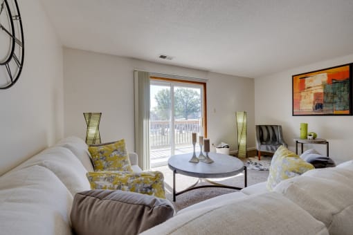 Spacious living room in the two-bedroom model unit at Olde English Village, with natural light and stylish furnishings.