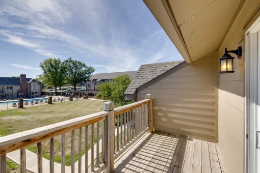 Balcony of a two-bedroom model unit at Olde English Village, offering outdoor space with views of the surrounding community.