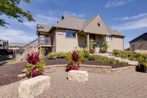 Exterior view of the clubhouse building at Olde English Village, surrounded by well-maintained landscaping and a welcoming atmosphere.