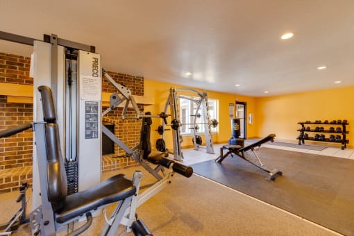 Workout area at Olde English Village, showcasing a clean space with cardio and strength-training equipment.