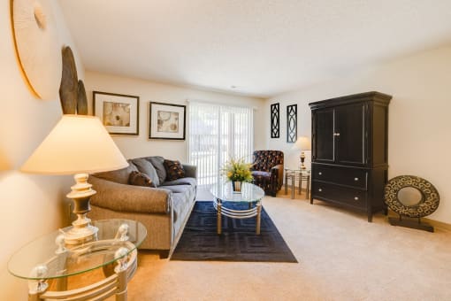 Regency Woods Model Unit - Living Room Living room in a Regency Woods model unit featuring a sofa and a table.
