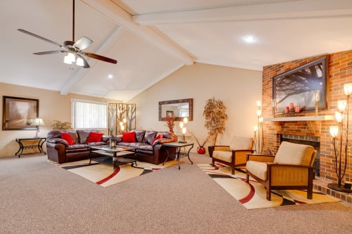 Regency Woods Community Clubhouse View of the living room in the Regency Woods Clubhouse featuring a fireplace and a couch.