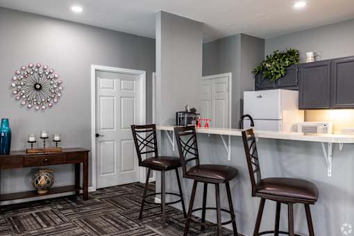 Southfork reception/office with a kitchen bar area and three chairs.