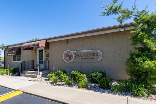 Exterior view of the Southfork Apartments clubhouse with surrounding greenery.