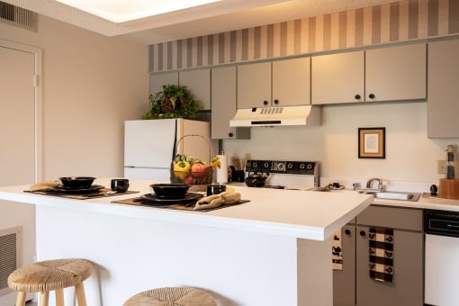 Spacious kitchen with wood cabinets, a stove, and open counter space, creating a homely cooking environment.