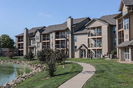 Three Lakes homes overlooking a peaceful pond, creating a welcoming setting for comfortable community living.