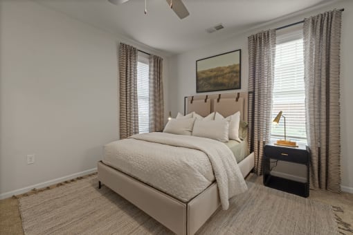 a bedroom with a bed and two windows