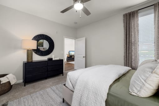 a bedroom with a bed and a ceiling fan