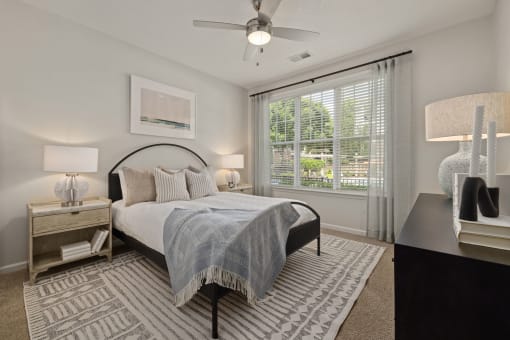 a bedroom with a bed and a ceiling fan
