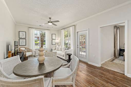 A living room with a dining table and chairs.