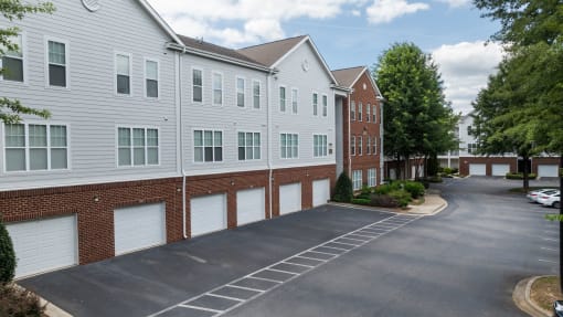 an empty parking lot in front of an apartment building
