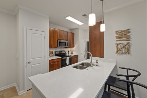 a kitchen with a large white counter top and a sink