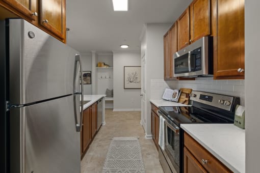 a kitchen with stainless steel appliances and wooden cabinets