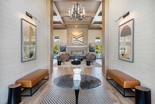 A modern living room with a fireplace and a chandelier.